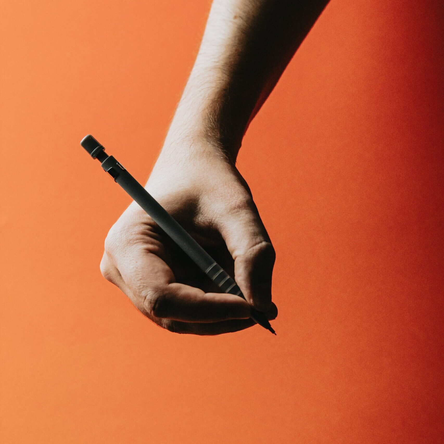 photo-of-a-hand-holding-a-pen-scaled.jpg
